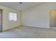 Neutral carpeted living room features a large window and arched doorway at 5582 Little Lake Ave, Las Vegas, NV 89122