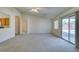 Living room featuring neutral carpet, high ceilings, and sliding glass door at 5582 Little Lake Ave, Las Vegas, NV 89122