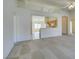 Open floor plan with neutral carpet and view into kitchen and dining area at 5582 Little Lake Ave, Las Vegas, NV 89122