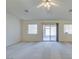 Bright living room with carpet, a ceiling fan, and sliding glass doors to the outdoor living space at 5582 Little Lake Ave, Las Vegas, NV 89122