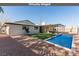 Backyard with pool, patio, and desert landscaping - perfect for entertaining and relaxation at 601 Sierra Ln, Henderson, NV 89002