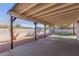 Covered patio and backyard featuring desert landscaping with rock and low-maintenance artificial turf at 601 Sierra Ln, Henderson, NV 89002