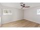 Bright bedroom with wood-look floors and ceiling fan at 601 Sierra Ln, Henderson, NV 89002