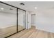 Bedroom with mirrored closet doors and wood-look floors at 601 Sierra Ln, Henderson, NV 89002