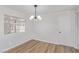 Bright dining room with modern light fixture and wood-look flooring at 601 Sierra Ln, Henderson, NV 89002