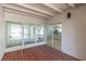 Enclosed patio featuring wood floors, beams and view to kitchen at 601 Sierra Ln, Henderson, NV 89002