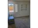 Bedroom with carpet flooring, window, and wall-mounted shelves at 6136 Evensail Dr, Las Vegas, NV 89156