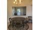 Dining area with a round table and chairs, overlooking the living room at 6136 Evensail Dr, Las Vegas, NV 89156