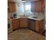 Kitchen corner featuring stainless steel dishwasher and wood cabinets at 6136 Evensail Dr, Las Vegas, NV 89156