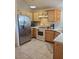 Galley kitchen with stainless steel appliances and wood cabinets at 6136 Evensail Dr, Las Vegas, NV 89156