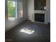 Living room featuring a fireplace, large window and carpet at 6136 Evensail Dr, Las Vegas, NV 89156