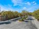 Gated community entrance with mature trees and landscaping at 6165 Smarty Jones Ave, Las Vegas, NV 89131