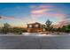 Two-story house at dusk with a three-car garage at 6165 Smarty Jones Ave, Las Vegas, NV 89131