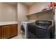 Laundry room with washer, dryer, and cabinets at 6165 Smarty Jones Ave, Las Vegas, NV 89131