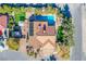 Aerial view highlighting a home's pool, lush yard, red-tile roof, and desert landscaping at 6185 N Conquistador St, Las Vegas, NV 89149