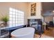 Luxurious bathroom with a freestanding tub, fireplace, and glass block window at 6185 N Conquistador St, Las Vegas, NV 89149