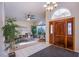 Spacious entryway with wood front door and decorative lighting at 6185 N Conquistador St, Las Vegas, NV 89149