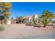 Single story house with a gated entrance and desert landscaping at 6185 N Conquistador St, Las Vegas, NV 89149