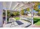 White pergola with seating area in backyard at 6185 N Conquistador St, Las Vegas, NV 89149