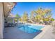 Rectangular pool in backyard with patio furniture and house visible at 6185 N Conquistador St, Las Vegas, NV 89149