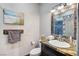 Clean bathroom with granite vanity, tiled shower, and beach themed decor at 7079 Mountridge Dr, Las Vegas, NV 89110