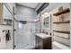 Modern bathroom with walk-in shower, floating vanity, and decorative shelving at 7079 Mountridge Dr, Las Vegas, NV 89110