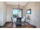 Bright dining room features a round table, four chairs, and large window at 7079 Mountridge Dr, Las Vegas, NV 89110