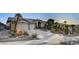 Single-story house with a three-car garage and desert landscaping at 7079 Mountridge Dr, Las Vegas, NV 89110