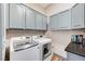 Laundry room with washer, dryer, and upper cabinets at 7079 Mountridge Dr, Las Vegas, NV 89110