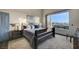 Main bedroom with a king-size bed and large windows showcasing a view at 7079 Mountridge Dr, Las Vegas, NV 89110