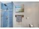 Blue tiled shower with a glass door and decorative accents at 7079 Mountridge Dr, Las Vegas, NV 89110