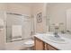 Simple bathroom features a shower/tub combo and wood vanity at 7517 Lintwhite St, North Las Vegas, NV 89084