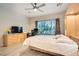 Bright bedroom with a large window, built-in shelving and light wood flooring at 7517 Lintwhite St, North Las Vegas, NV 89084