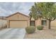 Inviting home exterior with a well-manicured lawn, two-car garage, and desert landscaping at 7517 Lintwhite St, North Las Vegas, NV 89084