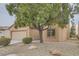 Single-story home with a beige exterior and mature tree at 7517 Lintwhite St, North Las Vegas, NV 89084