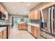 Modern kitchen with light wood cabinets, stainless steel appliances, and granite countertops at 7517 Lintwhite St, North Las Vegas, NV 89084