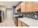 Modern kitchen with stainless steel appliances and light wood cabinets at 7517 Lintwhite St, North Las Vegas, NV 89084