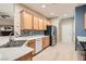 Modern kitchen with stainless steel appliances and light wood cabinets at 7517 Lintwhite St, North Las Vegas, NV 89084