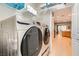 Laundry room with Samsung washer and dryer and overhead shelving at 7517 Lintwhite St, North Las Vegas, NV 89084