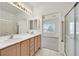 Double vanity bathroom with shower and view into bedroom at 7568 Lily Trotter St, North Las Vegas, NV 89084