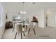 Virtually staged dining room featuring a round table and modern chandelier at 7568 Lily Trotter St, North Las Vegas, NV 89084