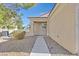 Front entry with walkway, decorative door, and drought-tolerant landscaping at 7568 Lily Trotter St, North Las Vegas, NV 89084