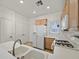 Kitchen with light wood cabinets, white appliances, and double sink at 7568 Lily Trotter St, North Las Vegas, NV 89084