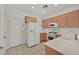 Efficient kitchen featuring light wood cabinets and white appliances at 7568 Lily Trotter St, North Las Vegas, NV 89084