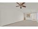 Bright and airy living room with neutral color palette and ceiling fan at 7568 Lily Trotter St, North Las Vegas, NV 89084