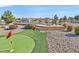 Elevated putting green with seating area and landscaping at 7568 Lily Trotter St, North Las Vegas, NV 89084