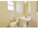 Small bathroom with pedestal sink and toilet at 7909 Dutch Canyon Ct, Las Vegas, NV 89131