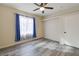 Bedroom with wood-look floors, ceiling fan, and window at 7909 Dutch Canyon Ct, Las Vegas, NV 89131