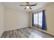 Spacious bedroom with wood-look floors and ceiling fan at 7909 Dutch Canyon Ct, Las Vegas, NV 89131