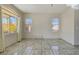 Bright living room with tile floors and large windows at 7909 Dutch Canyon Ct, Las Vegas, NV 89131